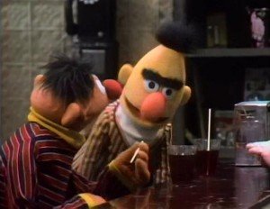 Bert teaches Ernie how to use a straw.