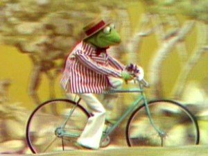 Kermit rides a bicycle to Miss Mousey!